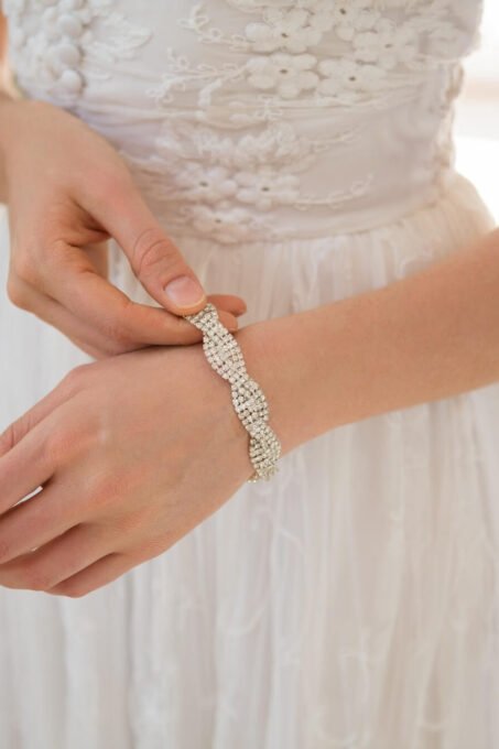 midsection-of-bride-wearing-bracelet-at-home.jpg